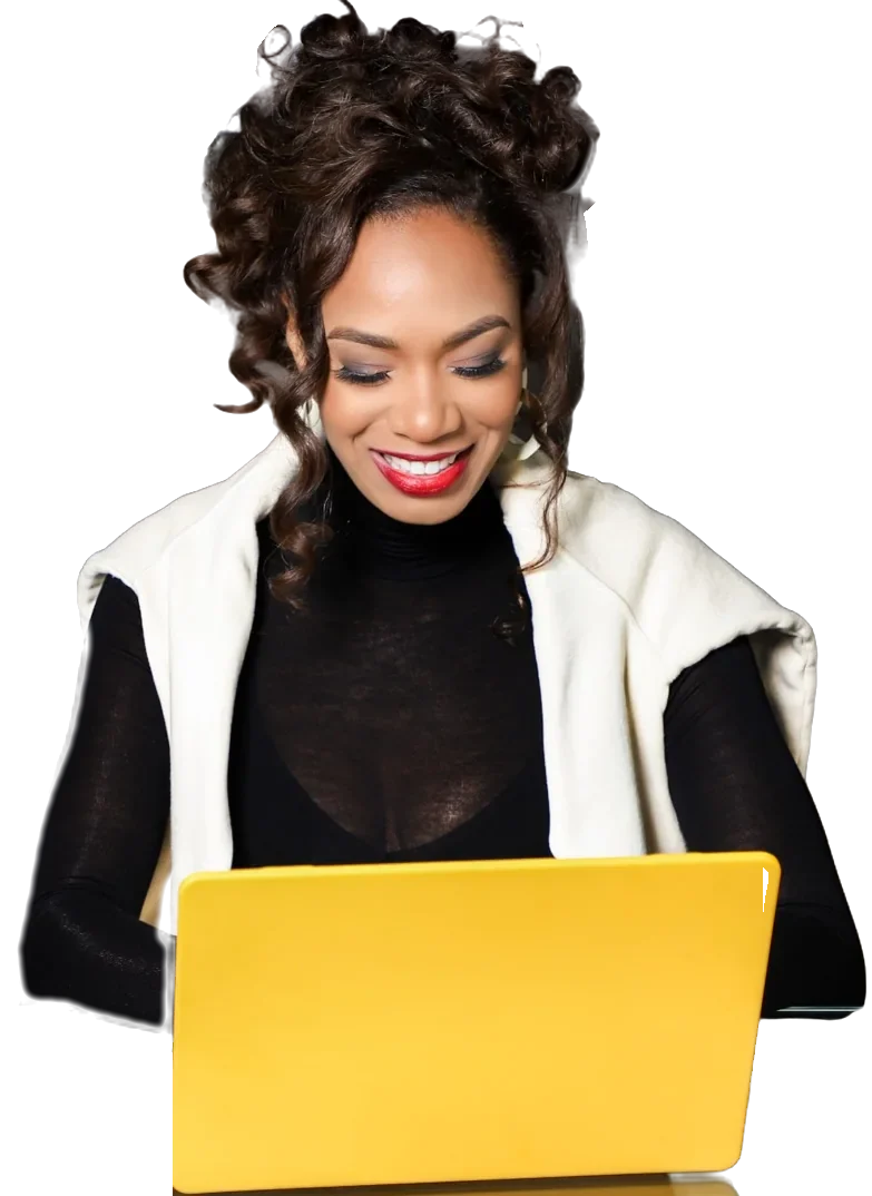 Damali smiling as she types on a yellow laptop